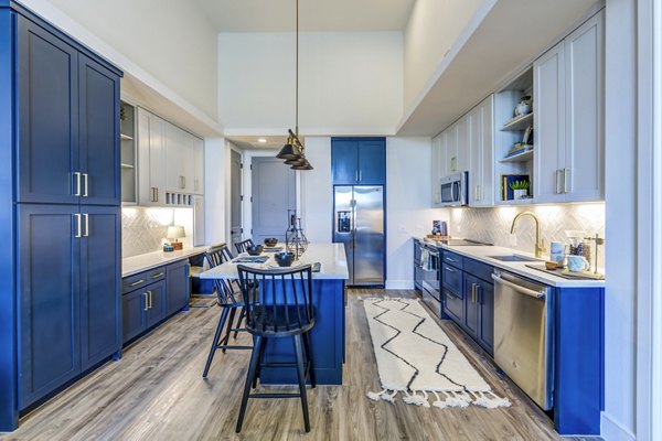 Modern kitchen with stainless steel appliances at The Margo Apartments