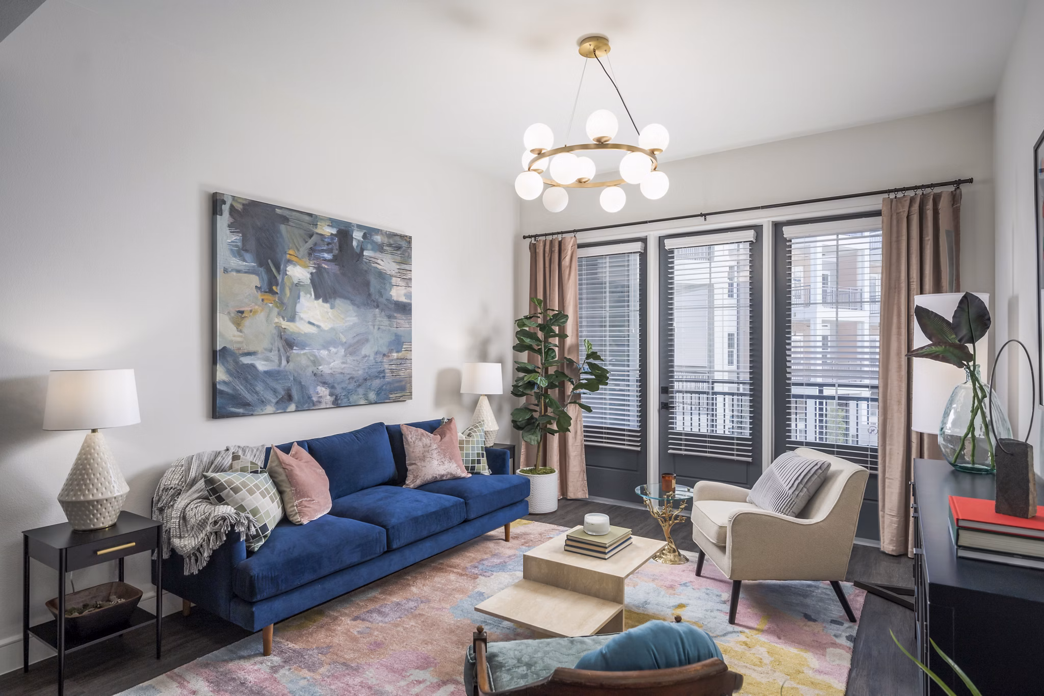 Modern living room with sleek furniture and large windows at The Margo Apartments
