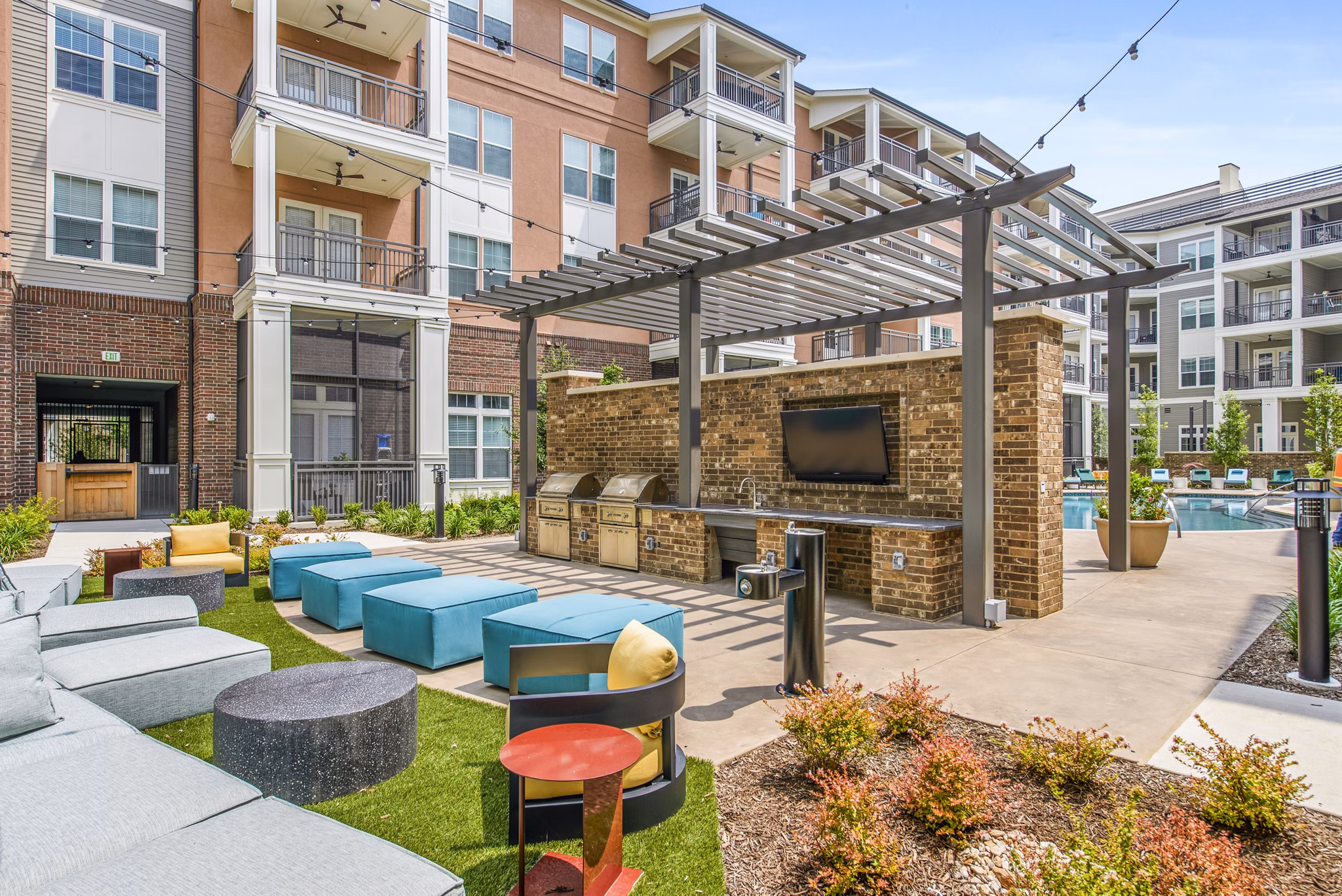 Outdoor grill area on the modern patio at The Margo Apartments offering luxury living experiences