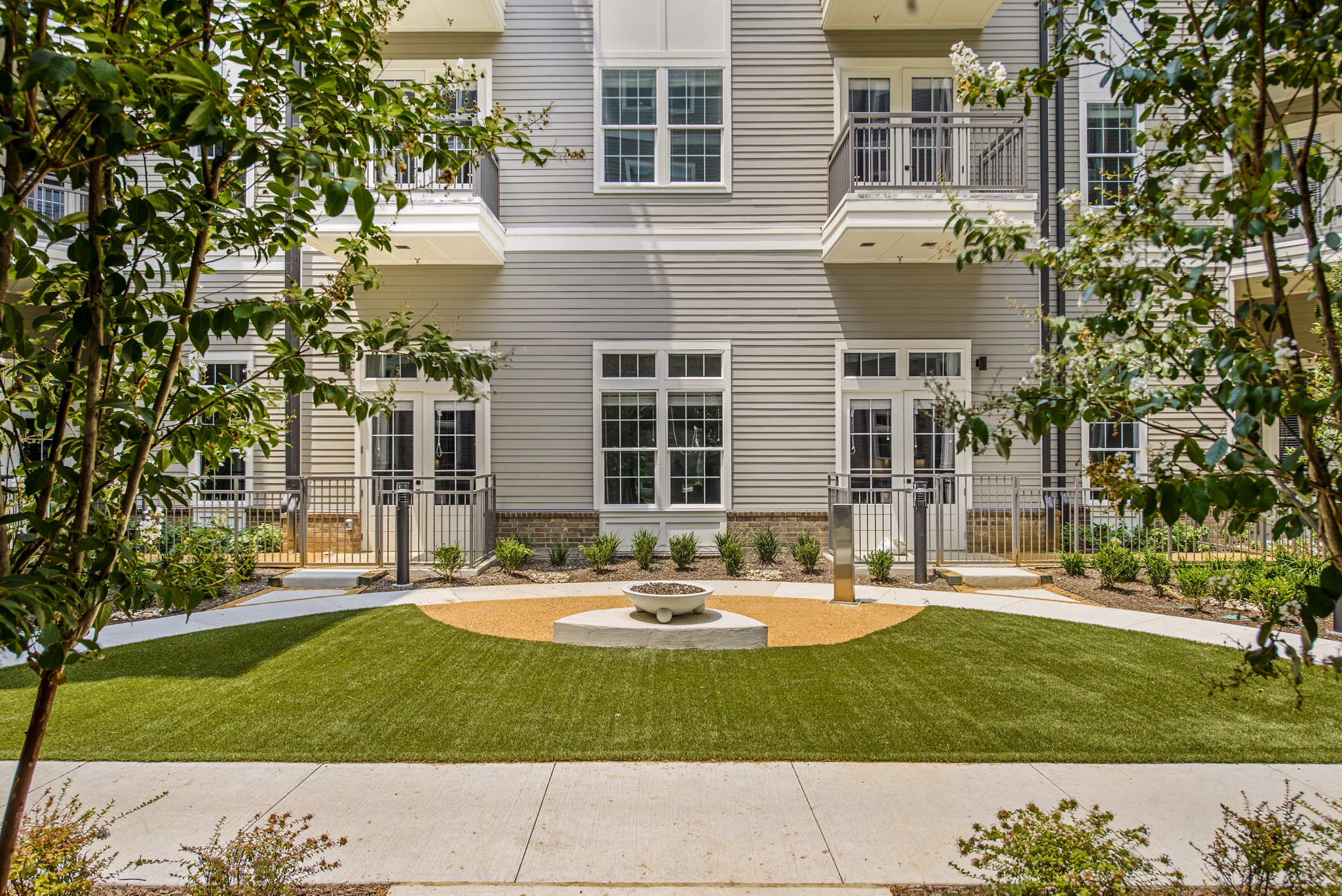 Dog-friendly patio area at The Margo Apartments with park-style seating and pet amenities