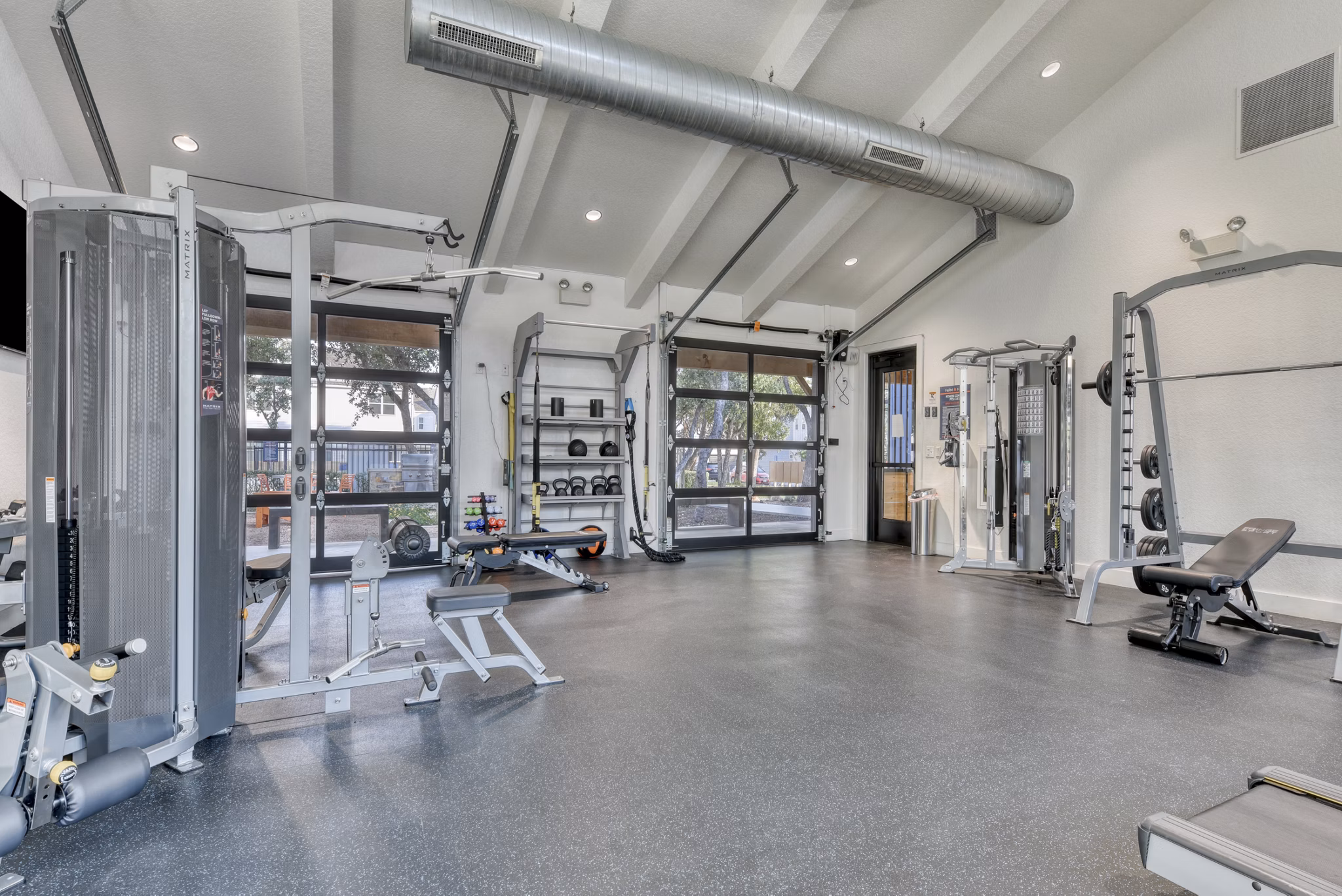 State-of-the-art fitness center at Farm Haus Luxury Rental Homes Apartments with modern equipment for resident workouts