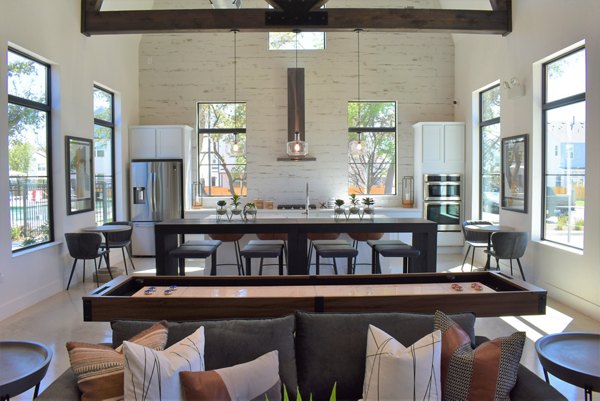 Modern kitchen with stainless steel appliances and granite countertops in Farm Haus Luxury Rental Homes Apartments