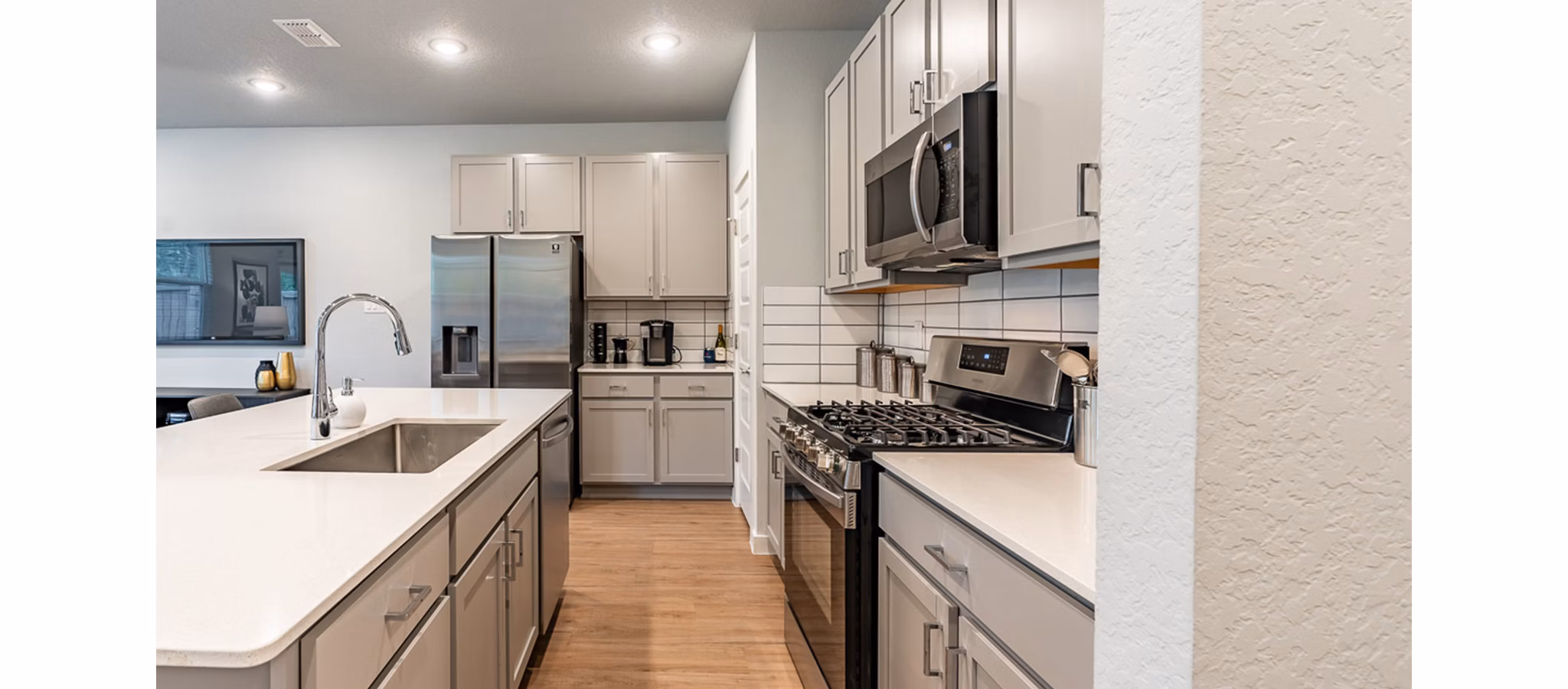 Modern kitchen with stainless steel appliances at Farm Haus Luxury Rental Homes Apartments