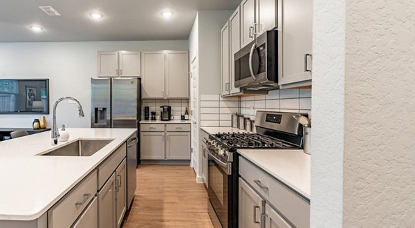 Modern kitchen with stainless steel appliances at Farm Haus Luxury Rental Homes Apartments