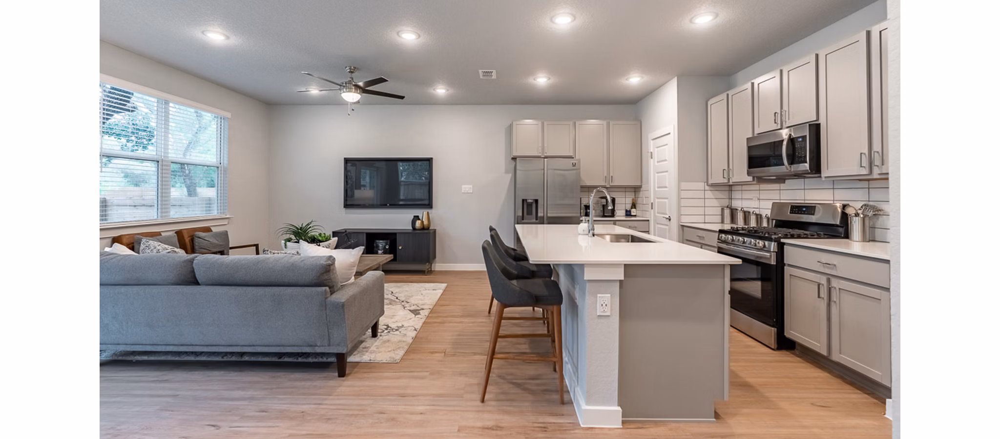 Modern kitchen with sleek appliances and granite countertops at Farm Haus Luxury Rental Homes Apartments