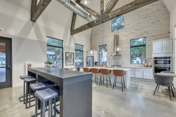Kitchen with modern appliances and quartz countertops at Farm Haus Luxury Rental Homes Apartments
