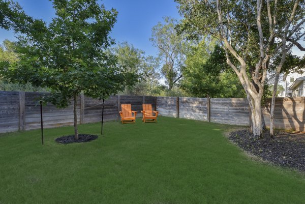 Courtyard with lush greenery and seating at Farm Haus Luxury Rental Homes