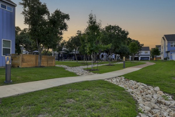 Playground with modern equipment at Farm Haus Luxury Rental Homes Apartments - family-friendly recreation area