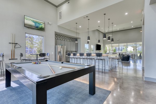 Modern clubhouse featuring lounge seating and entertainment areas at The View at TPC Apartments