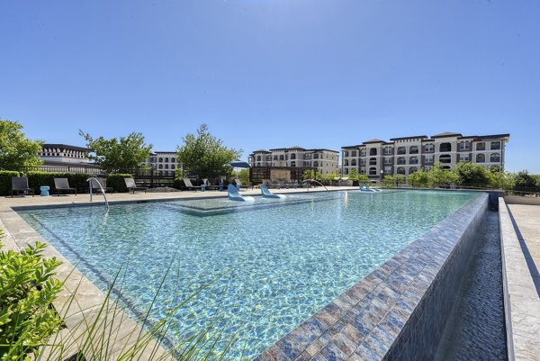 Luxurious pool with lounge seating at The View at TPC Apartments, perfect for relaxing and enjoying sunny days in a tranquil setting