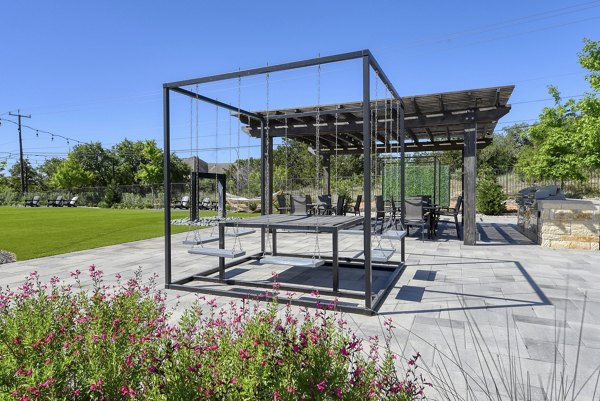 Outdoor courtyard featuring lush landscaping and seating areas at The View at TPC Apartments