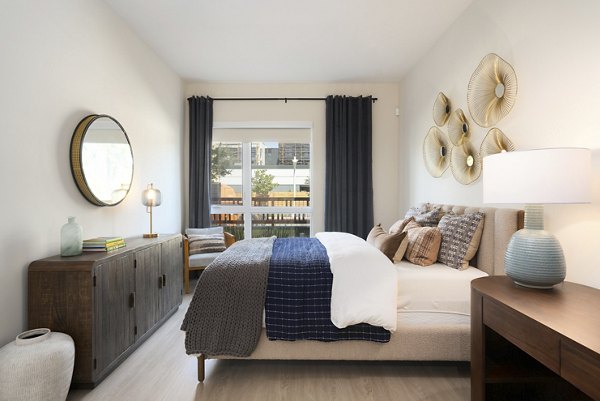 Modern bedroom with elegant decor at Rowe at Pear Village Apartments, showcasing luxury living in Greystar's portfolio