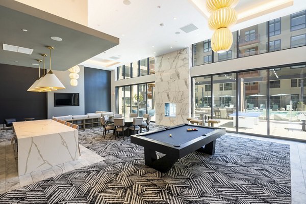 Clubhouse game room with billiards at Rowe at Pear Village Apartments offering luxury social spaces