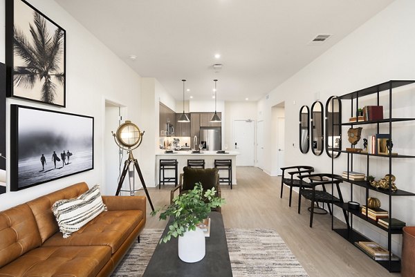 Living room featuring modern furniture and soft lighting at Quarter North Apartments