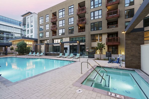 Outdoor pool and hot tub at Rowe at Pear Village Apartments offering luxury relaxation areas