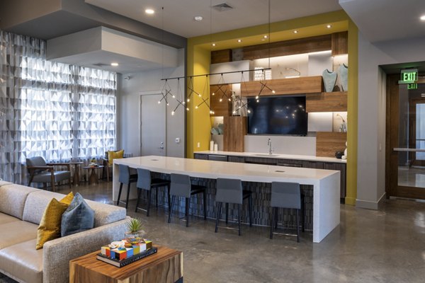Modern clubhouse with cozy seating and entertainment options at Union House Apartments