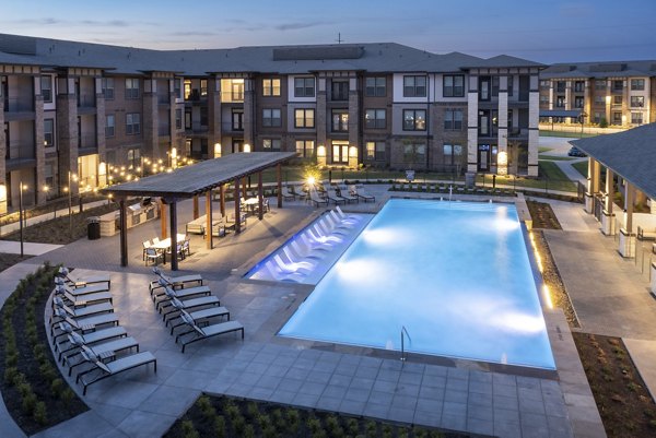 Resort-style swimming pool at Union House Apartments with luxury seating and lush landscaping