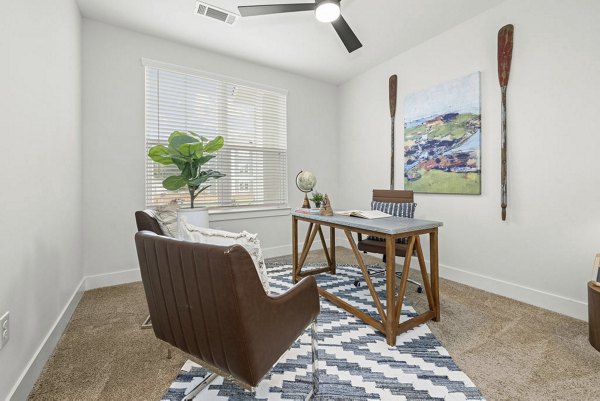 Home office with ergonomic desk and natural light at Evermore Apartments: luxury living spaces for productivity and comfort