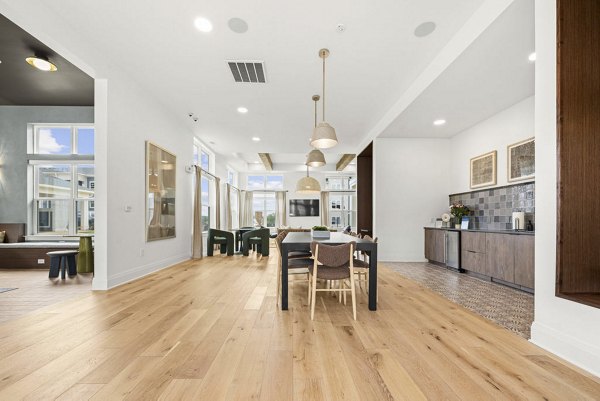 Clubhouse featuring modern seating and game area at Evermore Apartments