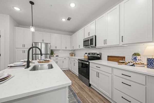 Kitchan at Evermore Apartments: Modern kitchen with stainless steel appliances and granite countertops in luxury apartment