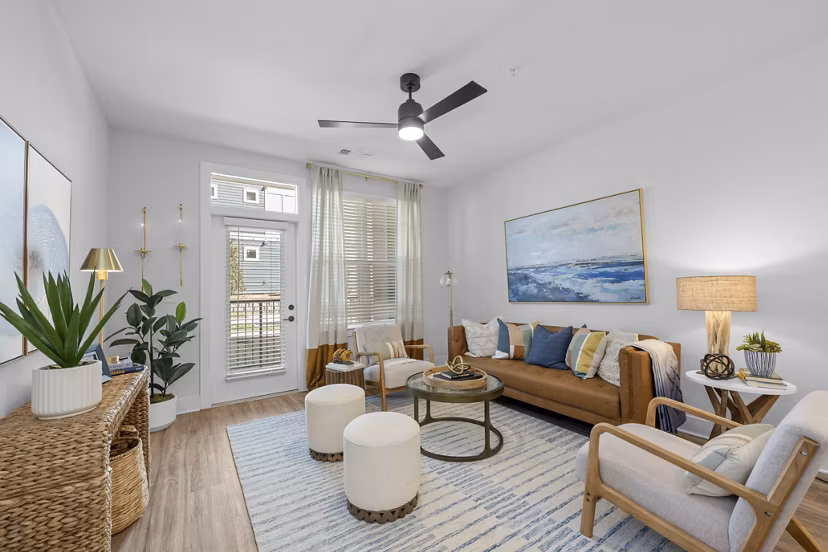 Spacious living room with modern decor and large windows in Evermore Apartments, a luxury community