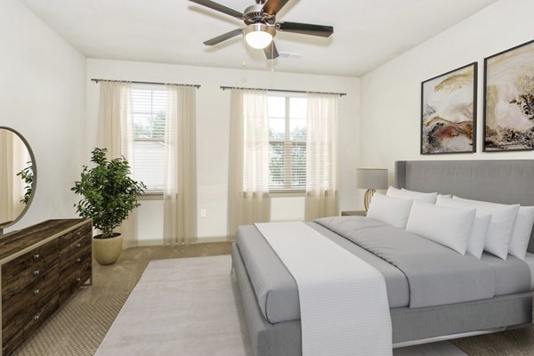 Modern bedroom with sleek furnishings and ample natural light at 401 Oberlin Apartments