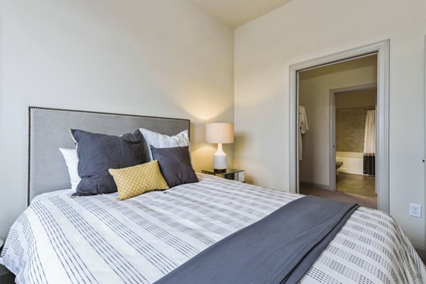 Bedroom featuring modern decor and large windows at 401 Oberlin Apartments, luxury living in midtown location for comfort and style