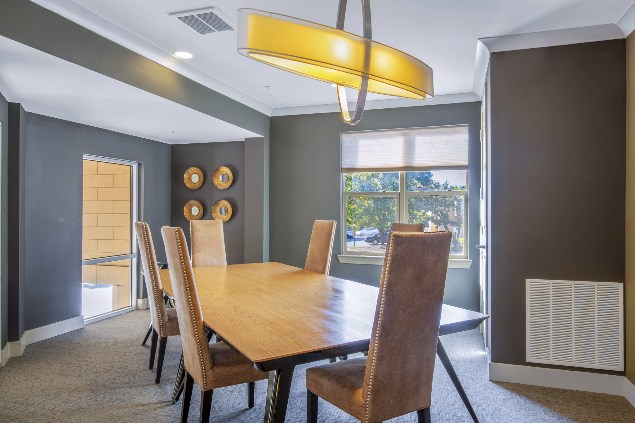 Clubhouse meeting facility with modern decor at 401 Oberlin Apartments, a luxury living community in vibrant Raleigh
