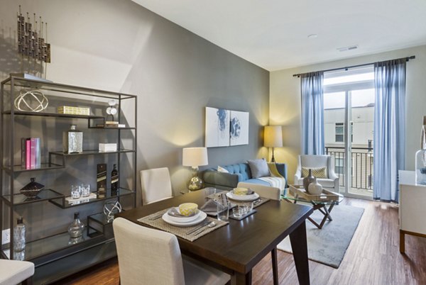 Dining room with modern decor featuring sleek furniture and large windows at 401 Oberlin Apartments in Raleigh