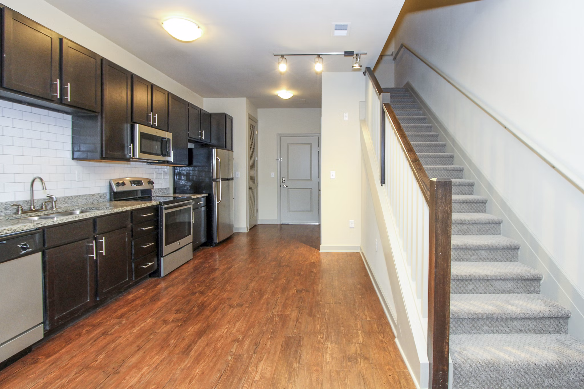 Modern kitchen equipped with stainless steel appliances and granite countertops at 401 Oberlin Apartments