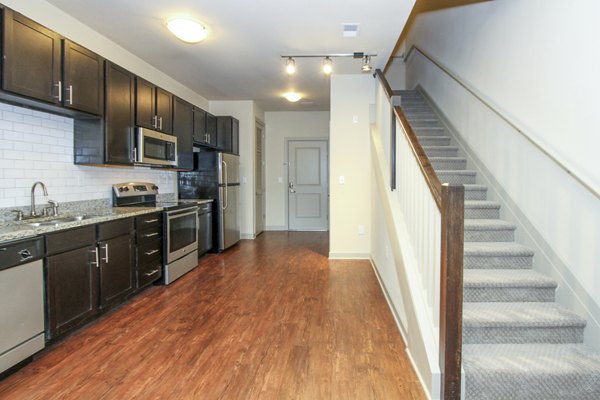 Modern kitchen equipped with stainless steel appliances and granite countertops at 401 Oberlin Apartments