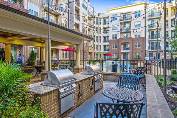 Outdoor grill area and patio at 401 Oberlin Apartments with modern furnishings, ideal for social gatherings and relaxation