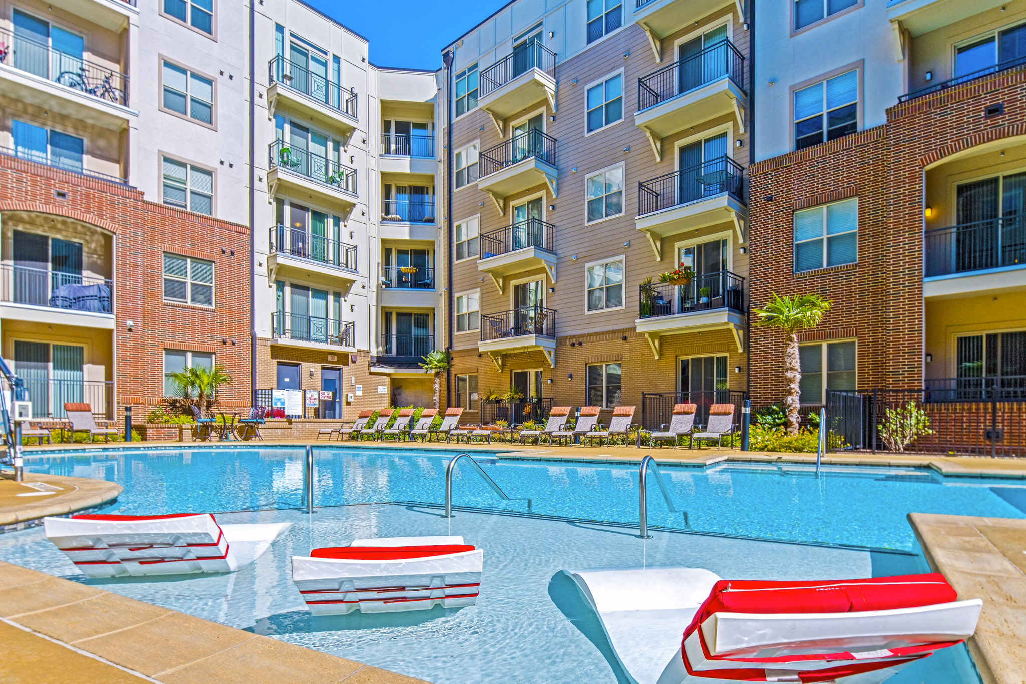 Infinity pool with sun deck at 401 Oberlin Apartments, a luxury Greystar community in Raleigh