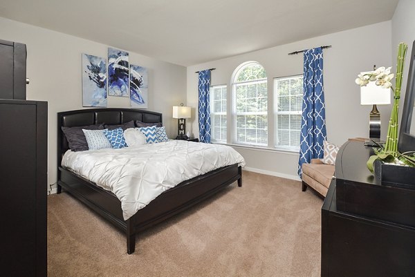 Bedroom featuring modern design and plush furnishings at 62 Eleven Apartments