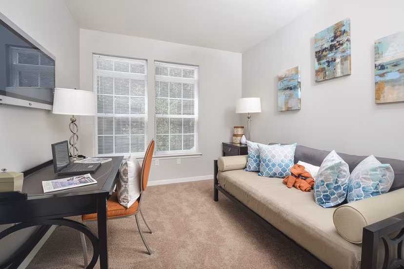 Cozy bedroom home office with modern desk and decor at 62 Eleven Apartments