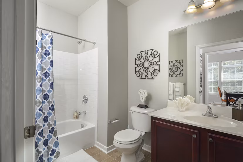 Modern bathroom featuring sleek fixtures and stylish tiling in 62 Eleven Apartments