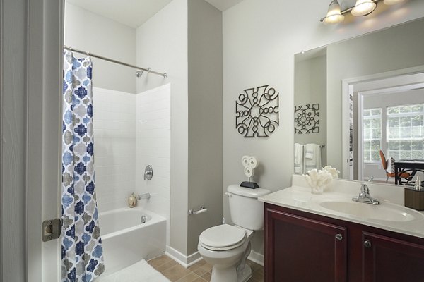 Modern bathroom featuring sleek fixtures and stylish tiling in 62 Eleven Apartments