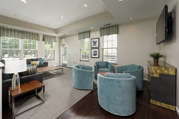 Clubhouse interior featuring modern seating areas and entertainment options at 62 Eleven Apartments, providing luxury living experiences