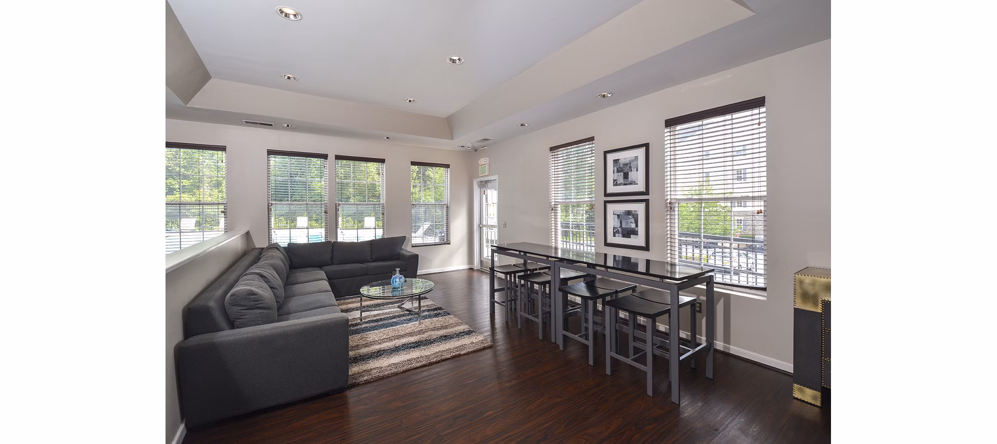 Clubhouse with modern decor and seating at 62 Eleven Apartments, ideal for social gatherings and leisure activities