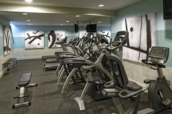 Fitness center with modern equipment at 62 Eleven Apartments, offering a range of workout options for residents seeking luxury living