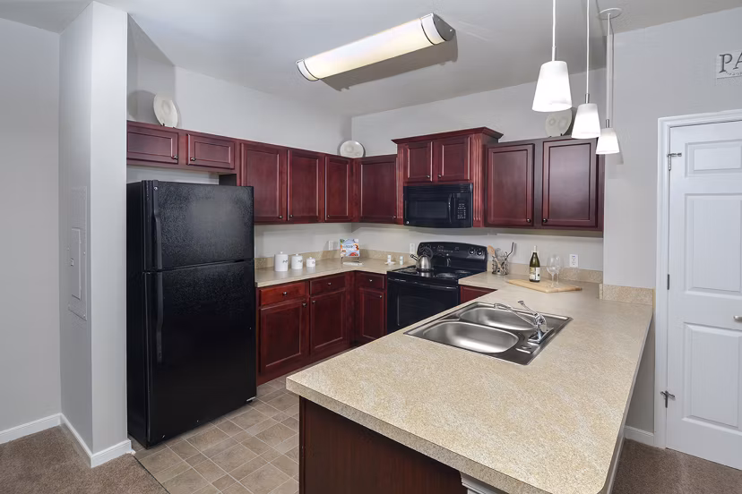 Modern kitchen with stainless steel appliances at 62 Eleven Apartments