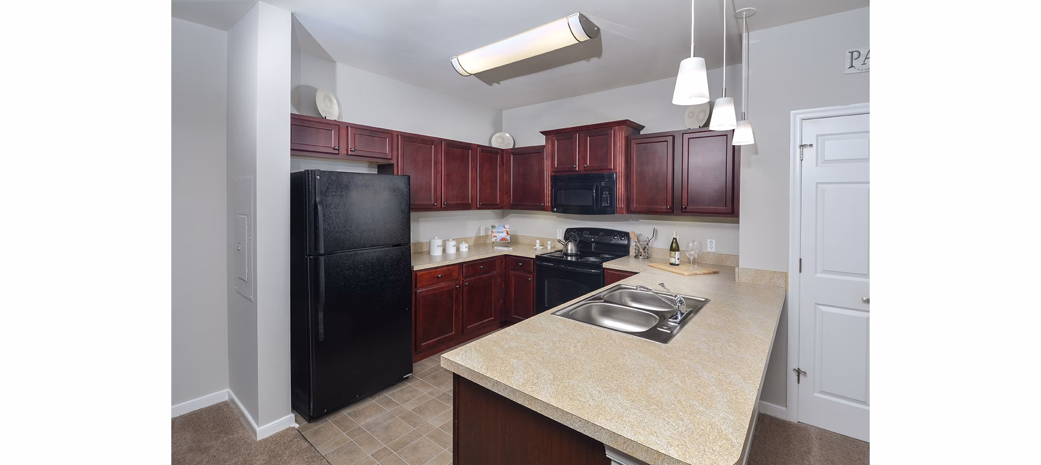 Modern kitchen with stainless steel appliances at 62 Eleven Apartments