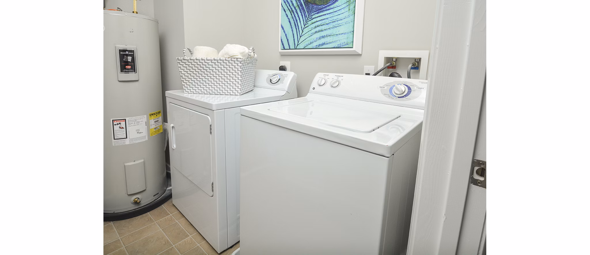 Laundry room with modern appliances at 62 Eleven Apartments, luxury living with convenient amenities in the Greystar community