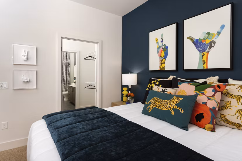Bedroom featuring elegant decor and plush bedding at 675 N Highland Apartments in Greystar's luxury community