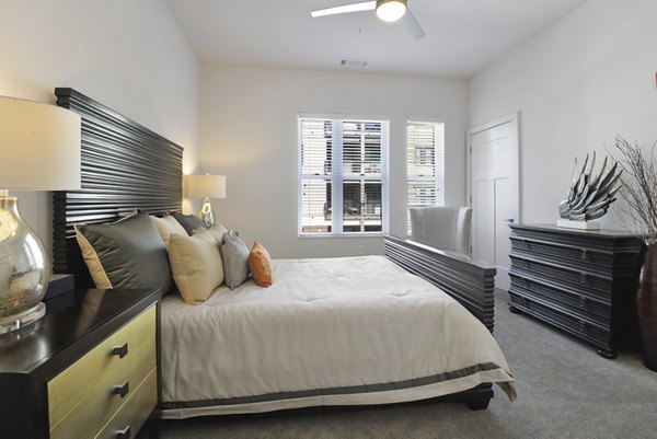 Bedroom featuring elegant decor and plush bedding at 675 N Highland Apartments in Greystar's luxury community