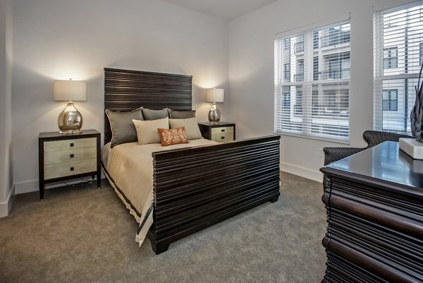 Cozy bedroom with stylish decor at 675 N Highland Apartments, offering luxury living spaces