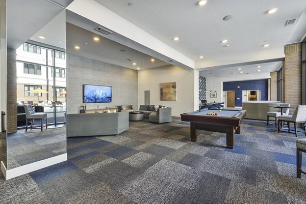 Clubhouse featuring modern design and ample seating at 675 N Highland Apartments