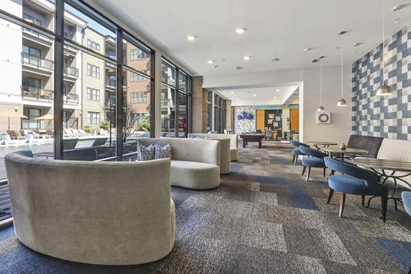 Clubhouse with modern design at 675 N Highland Apartments, featuring cozy seating and stylish decor