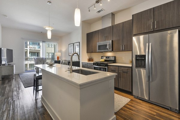 Kitchen featuring modern appliances and granite countertops at 675 N Highland Apartments