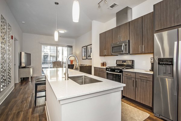 Modern kitchen with stainless steel appliances at 675 N Highland Apartments